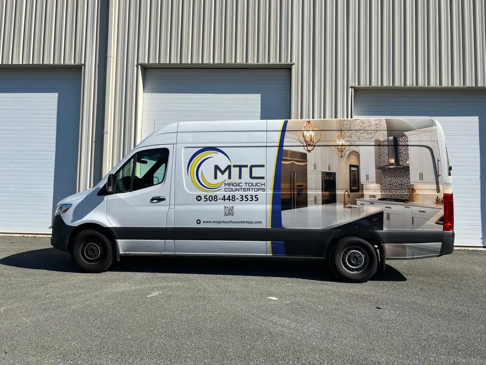 The Magic Touch Countertops van, wrapped with the MTC logo and the phone number, parked at the shop