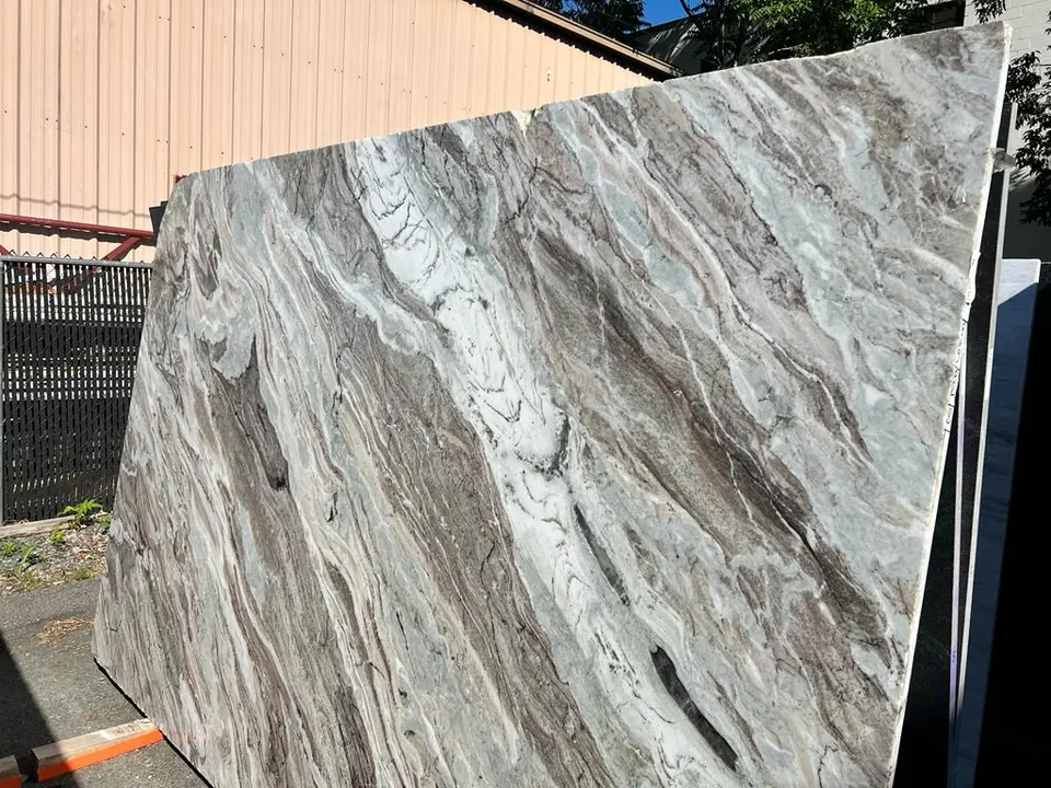 A full slab with flowing brown, gray and white waves, standing in the yard